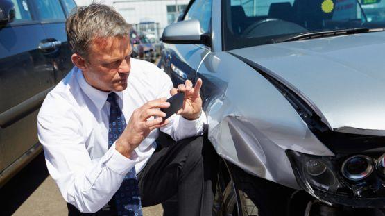 Field Adjuster in Suffolk County Taking Pictures of a damaged car