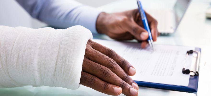 Injured Employee in Long Island Filling Out a Workers Compensation Claim Form